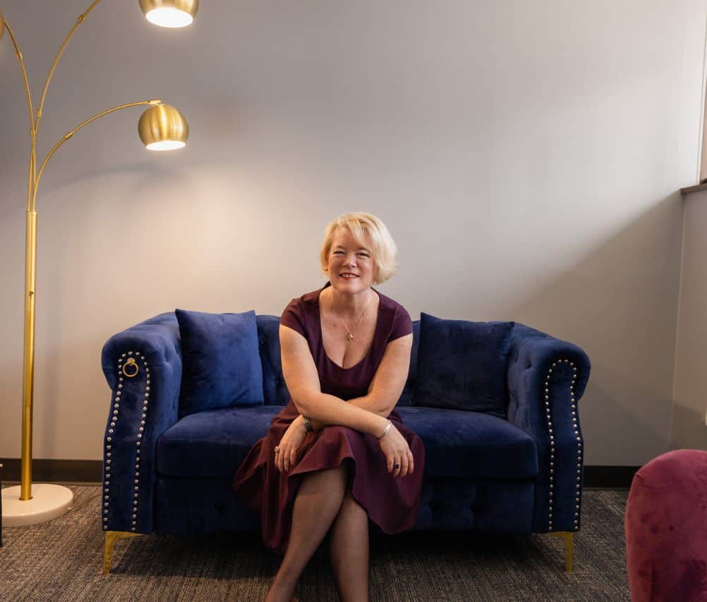 Alicia sitting on a couch